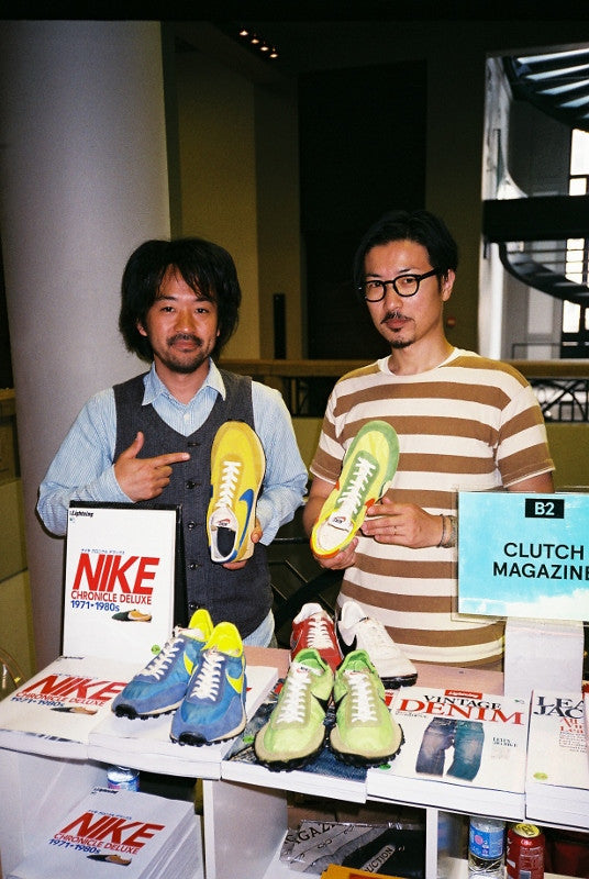 Tadayuki Miura in a striped tee and someone in a waistcoat holding vintage Nike trainers behind Nike Chronicle Deluxe books